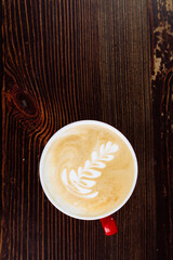 Fresh coffee with latte art in red cup