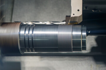 The  CNC lathe machine thread  cutting the metal shaft parts. - obrazy, fototapety, plakaty