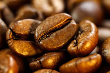 Dark brown roasted coffee is spinning. Coffee product advertising concept. Close up, macro. Selective Focus.