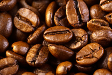 Roasted coffee beans, on a dark background. Espresso dark, aroma, black caffeine drink. Close up