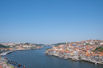 Naklejka na ściany i meble The Douro sings its eternal song in the crystalline view of Porto, a dance of lights and emotions in its waters.