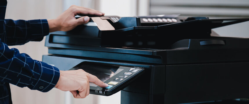 Copier printer, Close up hand office man press copy button on panel to using the copier or photocopier machine for scanning document printing a sheet paper.