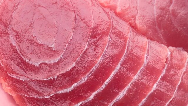 raw tuna steak, rotation in circle. close-up of Turning seafood. selective focus. pink fresh tuna fillet background