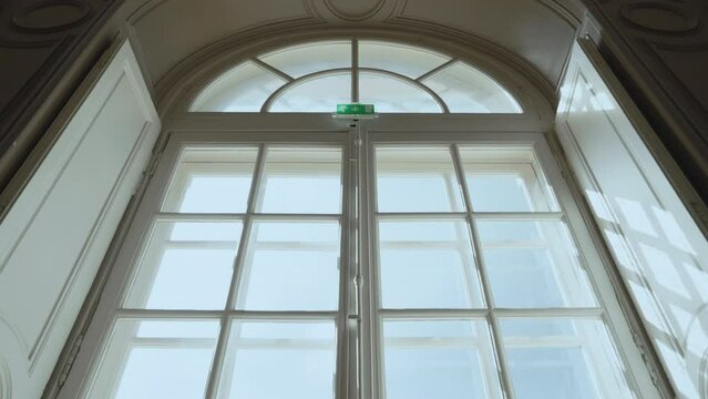 View of the garden from a vintage large window indoors