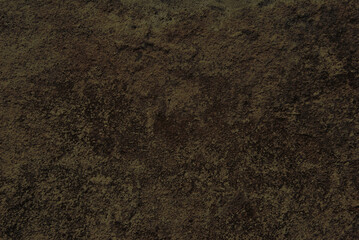A texture of old dark brown stone surface close up as background