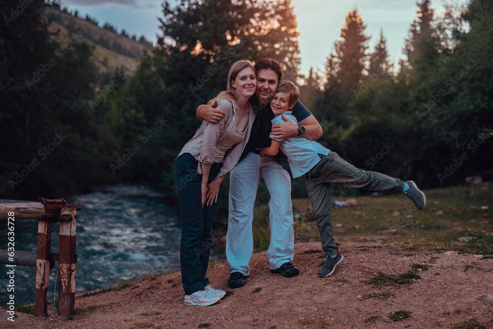 Canvas Prints Happy parents and their son posing by the mountain river at sunset