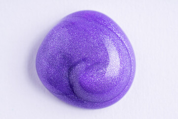 Lilac cosmetic cream smear on white background. Violet beauty cream smear swipe swatch closeup. Lavender face serum, lotion, moisturizer on white. Light purple paint swatch.