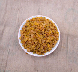 Top view of Delicious heathy raisins on the Jute fiber fabric