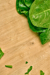 Fresh spinach leaves on a wooden cutting board