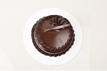 Top view of chocolate cake on white background