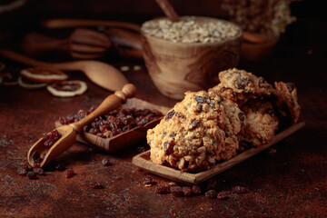 Oatmeal raisin cookies on a brown table.