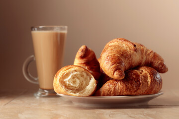 Freshly baked croissants and coffee with cream.