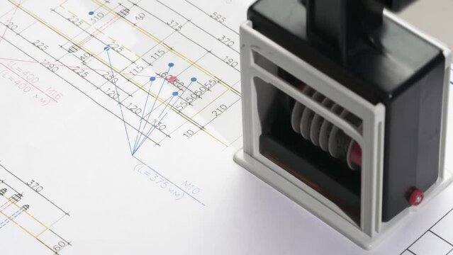 Building Drawing Approved. A stamp is placed on the design drawing and leaves an ink imprint symbolizing compliance with standards and building permission