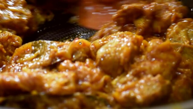 Cooking Mutton meat into the Cooking pan slow motion. Close up view of  Delicious Bengali meat cooking.