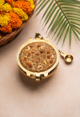 Onam Payasam served in golden bowl with flowers on the background