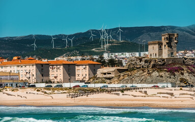 Seashore of Tarifa in Spain, Modern buildings and Old Castle of Guzman El Bueno, view on the beach