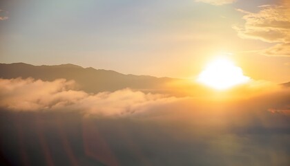 Natural fog and mountains sunlight background blurring, misty waves warm colors and bright sun light. Christmas background sky sunny color orange light patterns, abstract flare evening on clouds blur.