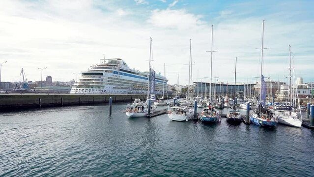View of spectacular Marina Real Harbour. Beautiful AIDA cruise docked in the bay. Yachts and fishing boats. Travel destination in Galicia, SPAIN. Stabilized.