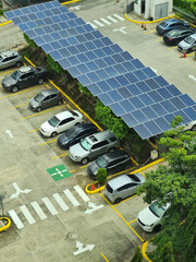 Cars in parking lot under solar panel roof