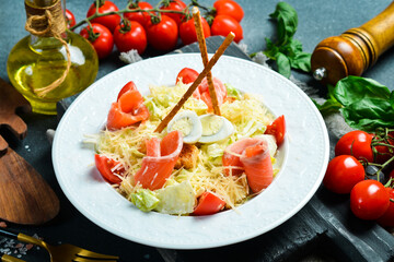 Caesar salad with salmon. Fresh salad in a plate. Top view. Photo for the menu.