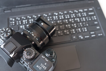 Camera lens and laptop computer of photographer for set create photo and adjust photo and maintenance dirty small dust in camera concept.