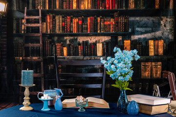 steaming coffee in blue mug blue flowers on blue table with vintage camera and retro looking library background
