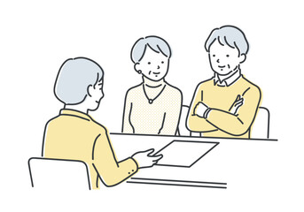 担当者の説明を聞くシニア夫婦