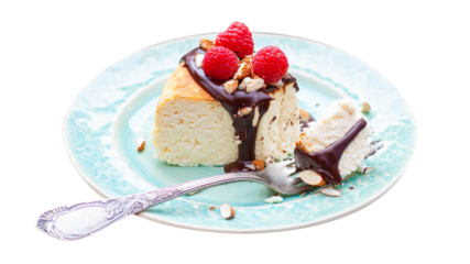 Slice of vanilla cheesecake with chocolate sauce, fresh raspberry and nuts on blue plate, close up view