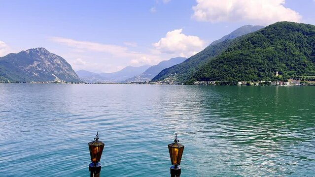 Lamp on Alpine Lake Lugano and Mountain in a Sunny Day in Melide and Bissone in Ticino, Switzerland.