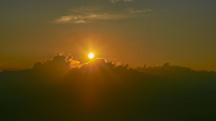 Summer evening sky in the picturesque clouds, lit by the rays of the setting sun.
