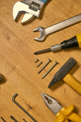 Hand tools, construction tools on a wooden surface.