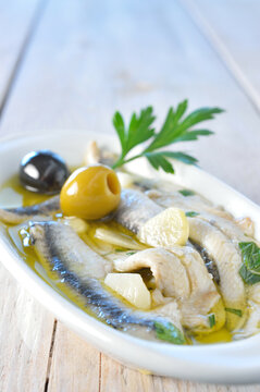 Close-up of boquerones with olive oil and vinegar.