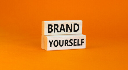 Brand yourself symbol. Concept words Brand yourself on beautiful wooden block. Beautiful orange table orange background. Business brand yourself concept. Copy space.