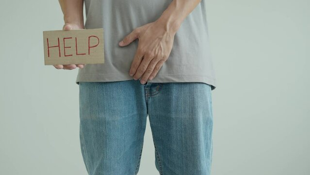 Man hold hand in front of private parts feeling discomfort from disease and inflammation. Venereal, testicular cancer. bladder problems, erectile dysfunction, premature ejaculation, prostate cancer