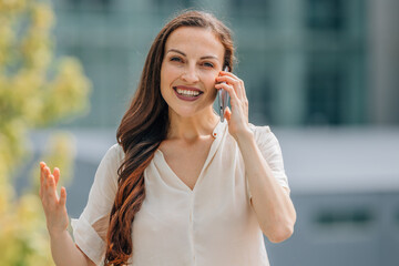 business woman talking on mobile phone in the street