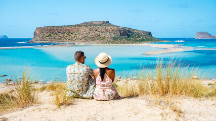Crete Greece, Balos lagoon on Crete island, Greece. Tourists relax at the crystal clear ocean of...