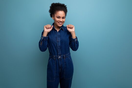 Portrait Of Charming Slim Young Hispanic Brunette Woman With Fluffy Curly Hair In Blue Denim Suit