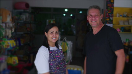 Pet Shop Owner and Customer posing for camera in front of Local Small Business. Female Entrepreneur...