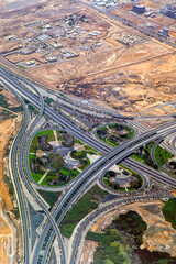 Aerial view of highway interchange. Road junction. Residential buildings, squares and streets in Oman