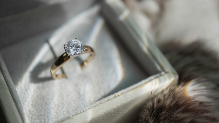Close up of diamond ring with sunlight and shadow background. Love, valentine, relationship and...