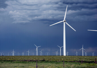 Wind turbine energy is a modern windmill generating electricity and clean energy wind power on the plains of Colorado, USA