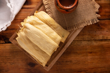 Fototapeta na wymiar Tamales. Prehispanic dish typical of Mexico and some Latin American countries. Corn dough wrapped in corn leaves. The tamales are steamed.