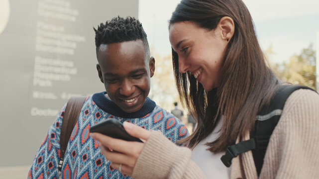 Close-up Of A Guy And A Girl Talking To Each Other And Using A Mobile Phone