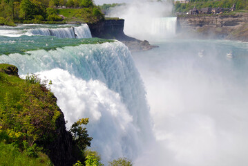 close view to American Niagara Falls with Canadian Horseshoe Falls in the Background
