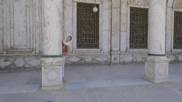 Woman is standing near column at the Great Mosque of Muhammad Ali Pasha.