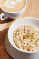 Oatmeal porridge with coffee. Concept healthy breakfast food, modern mood