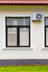 outdoor air conditioning unit installed on the facade of the house