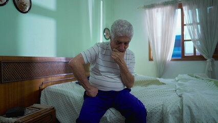 Thoughtful Elderly Man Pondering Decision, Seated by Bedside in Gloomy Bedroom Contemplation