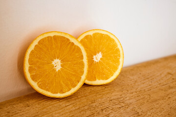 Slices of organic orange on a wooden cutting board.