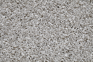 Background small fractions of crushed stone with sand frozen in cement mortar close-up